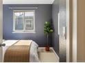 Cozy bedroom with a comfortable bed, soft lighting, and a plant by the window at 3251 N Madison St, Denver, CO 80205