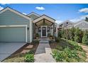 Inviting front porch with charming details and a well-manicured garden leading to the entrance at 10624 W Berry Pl, Littleton, CO 80127