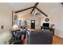 Cozy living room with vaulted ceiling, exposed wood beams, hardwood floors, and comfortable seating at 10624 W Berry Pl, Littleton, CO 80127