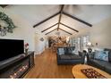 Spacious living room with fireplace, wood floors, and open layout to dining area and kitchen at 10624 W Berry Pl, Littleton, CO 80127