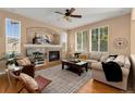 Bright living room boasts a fireplace, large windows, and neutral decor at 13794 E Caley Dr, Englewood, CO 80111
