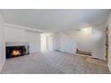 Open living room featuring a fireplace, neutral-toned furniture, and seamless flow for entertaining at 1180 S Troy St, Aurora, CO 80012