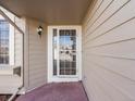 Covered front porch with security screen door at 9696 Pinebrook St, Highlands Ranch, CO 80130