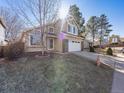 Beautiful two-story home features an attached garage, large windows, and attractive landscaping at 9696 Pinebrook St, Highlands Ranch, CO 80130
