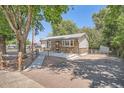 View of a well maintained single story home with a fenced yard and a walkway to the front door at 1390 Estes St, Lakewood, CO 80215