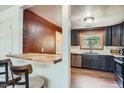 Modern kitchen with stainless steel appliances, ample counter space, and a stylish breakfast bar at 1390 Estes St, Lakewood, CO 80215