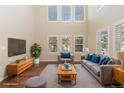 Bright living room with hardwood floors, high ceilings, and stylish furnishings at 5596 W 72Nd Dr, Arvada, CO 80003