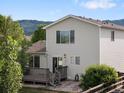 Charming two-story home featuring a private backyard, wood deck, lush landscaping, and partial fencing at 7720 Brown Bear Way, Littleton, CO 80125