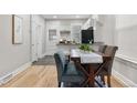 Bright dining area featuring wood floors, a table set for four, and stainless steel appliances in the background at 3045 Arapahoe St, Denver, CO 80205