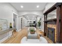 Elegant living room with hardwood floors, a decorative fireplace, and an open floor plan leading to the dining area at 3045 Arapahoe St, Denver, CO 80205