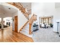 Spacious foyer with a curved staircase, hardwood floors, and an arched entrance to the dining room at 8316 Green Island Cir, Lone Tree, CO 80124