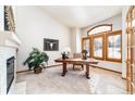 Bright home office with a fireplace, natural light, and a cozy atmosphere at 8316 Green Island Cir, Lone Tree, CO 80124