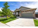 Attractive single-Gathering home showcasing a well-kept lawn, stone details, and a two-car garage at 15392 W 49Th Ave, Golden, CO 80403