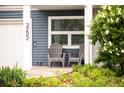 Inviting front porch with comfortable gray seating, perfect for enjoying the outdoors at 3202 S Dahlia St, Denver, CO 80222