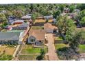 Aerial view of a charming home with a detached garage, fenced yard, and mature trees at 2226 Fulton St, Aurora, CO 80010