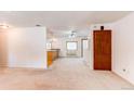 Open-concept living space with neutral carpet and a view into the adjacent kitchen and dining area at 16291 E 7Th Dr, Aurora, CO 80011