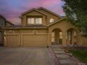 Inviting two-story home with three-car garage and covered porch, perfect for outdoor relaxation and curb appeal at 2544 S Fundy Cir, Aurora, CO 80013