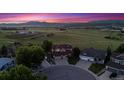 Aerial view of a landscaped home in a neighborhood with surrounding fields and mountain views at 4099 Starflower Rd, Castle Rock, CO 80109