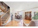 Bright dining room with hardwood floors, elegant furniture, staircase, and large windows at 4099 Starflower Rd, Castle Rock, CO 80109