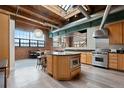 Spacious open concept kitchen with modern appliances, a large island, and exposed brick accents at 1515 N Ogden St # 7, Denver, CO 80218