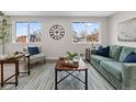 Bright living room featuring a comfortable sofa, stylish decor, and large windows for natural light at 8051 Clarkson Ct, Denver, CO 80229