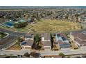 Panoramic aerial view of a neighborhood with green spaces, streets, and rooftops with solar panels at 10152 Southlawn Cir, Commerce City, CO 80022