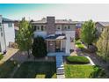 Beautifully landscaped front yard with stone walkway leading to a charming two-story home at 10152 Southlawn Cir, Commerce City, CO 80022