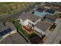 Aerial view of the back of the home, featuring a wood deck and landscaped backyard at 10152 Southlawn Cir, Commerce City, CO 80022