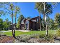 Charming two-story home featuring a two-car garage, lovely stone accents and a welcoming front entrance at 26176 Sweetbriar Trl, Evergreen, CO 80439