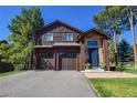 Charming two-story home featuring a two-car garage, lovely stone accents and a welcoming front entrance at 26176 Sweetbriar Trl, Evergreen, CO 80439