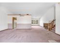 Bright and airy living room offering high ceilings and an open layout with views and a staircase at 835 S Geneva St, Aurora, CO 80247