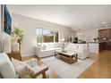 Inviting living room with large windows and a comfortable sectional couch, perfect for relaxing and entertaining at 11886 E Fair Ave, Greenwood Village, CO 80111
