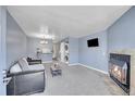 Cozy living room with a fireplace, washer, dryer, and modern décor at 1662 S Blackhawk Way # A, Aurora, CO 80012