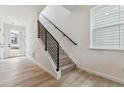 Stylish staircase with modern railings and bright natural light from a window at 8480 Eagle River St, Littleton, CO 80125