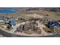 Expansive aerial view showcasing the home, its large lot, and surrounding neighborhood with pond at 3545 Cottonwood Cir, Longmont, CO 80504