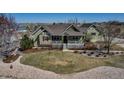 Charming home showcasing a well-manicured lawn and inviting front porch, perfect for relaxing outdoors at 3545 Cottonwood Cir, Longmont, CO 80504