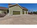 Spacious three-car garage with ample parking space and neutral exterior, enhancing curb appeal at 3545 Cottonwood Cir, Longmont, CO 80504