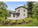 Lovely home with colorful accents, a welcoming front patio, and a beautifully landscaped yard at 5071 Parmalee Gulch Rd, Indian Hills, CO 80454