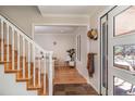 Bright foyer with hardwood floors and staircase leading to the upper level of the home at 1740 Bear Mountain Dr, Boulder, CO 80305