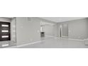 Bright living room with sleek tile flooring, modern finishes, and open layout at 9950 W 17Th Ave, Lakewood, CO 80215
