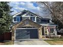 Charming two-story home with a stone-accented garage and inviting front porch at 19346 E Prentice Ln, Centennial, CO 80015