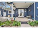 Inviting covered front porch with chairs, decor, and charming details offering a warm welcome at 8007 S Dover St, Littleton, CO 80128