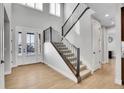 Light-filled entryway, featuring hardwood floors and a modern staircase at 359 Castlemaine Ct, Castle Rock, CO 80104