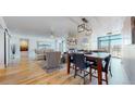 Open dining area with hardwood floors and modern light fixture at 1777 Larimer St # 1608, Denver, CO 80202