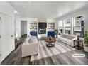 Bright living room with large windows, built-in shelving, fireplace, modern furniture, and stylish decor at 4940 Akron St, Denver, CO 80238