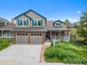 Charming home featuring a brick facade, a two-car garage, and a cozy front porch at 18 Blue Sage, Littleton, CO 80127