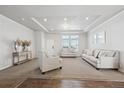 Bright and airy living room with neutral decor and hardwood floors at 4220 Headlight Rd, Strasburg, CO 80136