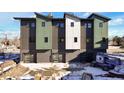 View of townhomes' rear, highlighting garages and updated construction area at 5193 Carr St, Arvada, CO 80002