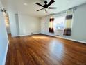 Inviting living room showcasing hardwood floors, a ceiling fan, and natural light at 2027 S Newton St, Denver, CO 80219
