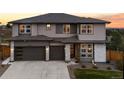 Charming home featuring a two-car garage, stone accents, and well-maintained landscaping at 6405 Kenzie Cir, Castle Pines, CO 80108